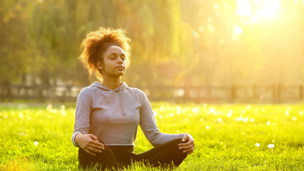 Person practicing deep breathing to manage daily stress